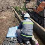 Kỹ sư kiểm tra thiết kế xây dựng tại công trường với máy xúc EX35 2026